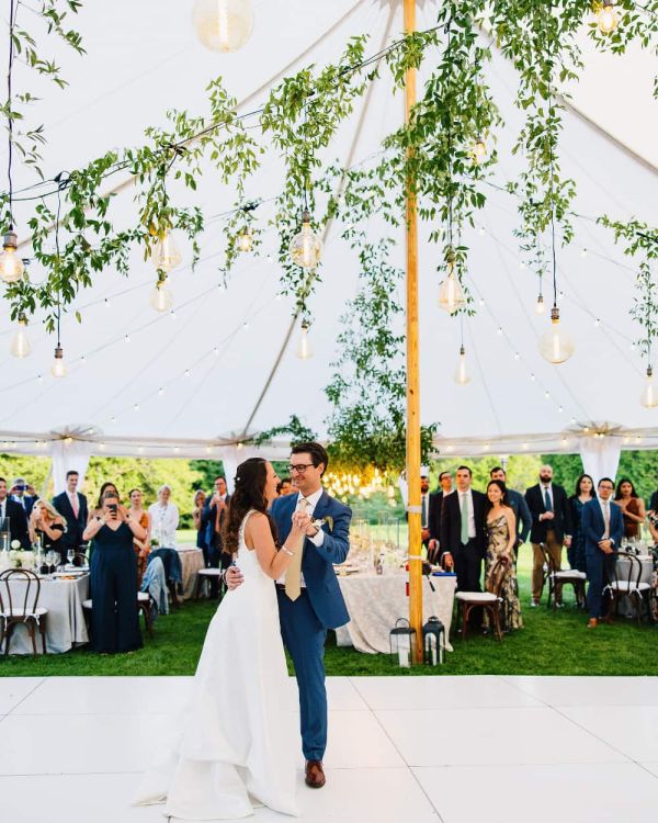 Bride and groom dancing at wedding under lights